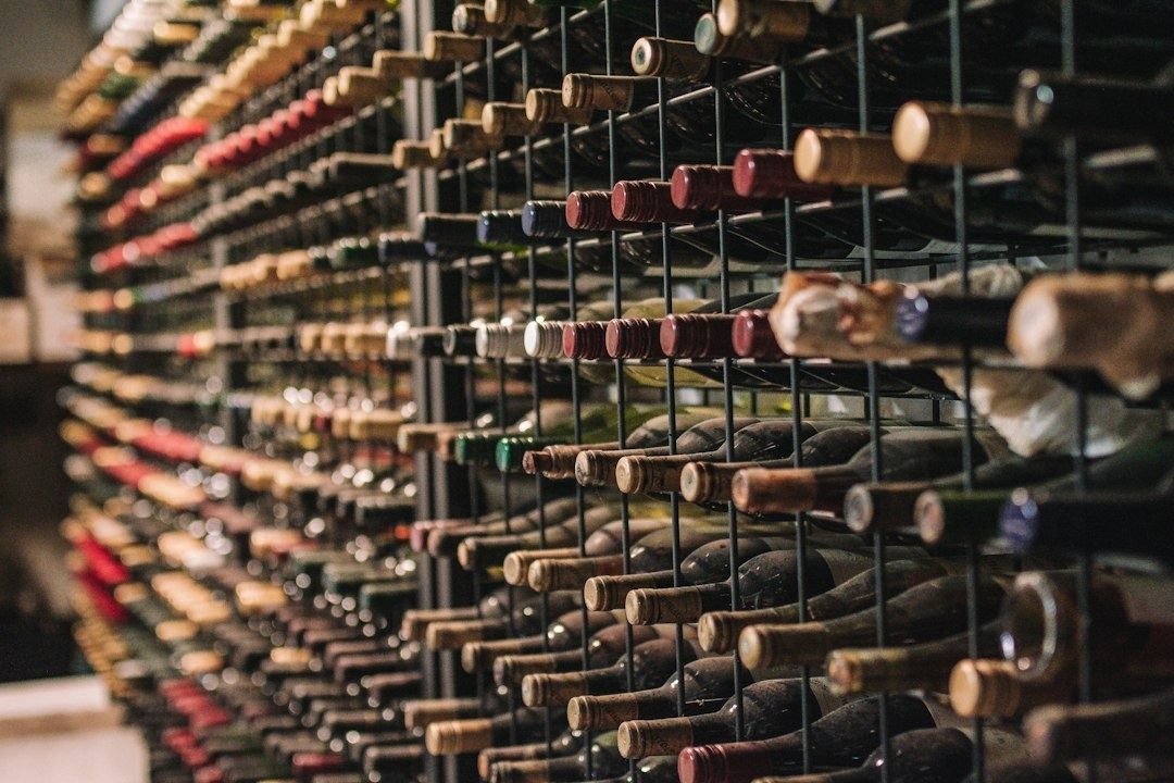 Rows of wine bottles stored horizontally in a cellar rack
